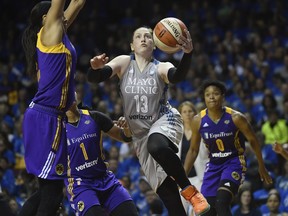 FILE - In this Sept. 26, 2017, file photo, Minnesota Lynx guard Lindsay Whalen (13) goes to the basket against the Los Angeles Sparks during the second half of Game 2 of the WNBA finals in Minneapolis. The Minnesota Lynx will honor Lindsay Whalen with a ceremony this season to mark the first jersey retirement by the 20-year-old franchise. The Lynx announced Thursday, April 18, 2019, they will hang Whalen's number 13 from the Target Center rafters, at their June 8 game against the rival Los Angeles Sparks.