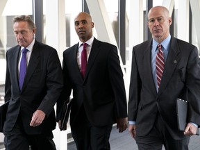 FILE - In this April 1, 2019, file photo, former Minneapolis police officer Mohamed Noor, center, arrives for the first day of jury selection with his attorneys Peter Wold, left, and Thomas Plunkett, at the Hennepin County Government Center in Minneapolis, Minn. Noor is charged in the July 2017 death of Justine Ruszczyk Damond, who was killed after she called 911 to report a possible sexual assault behind her home.