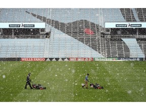 Members of the grounds crew cut the grass as snow falls Friday, April 12, 2019, at Allianz Field in St. Paul, Minn. Minnesota United host New York City FC in their home-opening MLS soccer game on Saturday at the stadium.