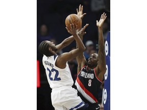 Minnesota Timberwolves' Andrew Wiggins shoots over Portland Trail Blazers' Al-Farouq Aminu in the first half of an NBA basketball game Monday April 1, 2019, in Minneapolis.