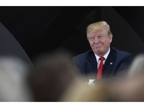 President Donald Trump listens during a discussion at Nuss Truck and Equipment in Burnsville, Minn., Monday, April 15, 2019, during an event to tout the 2017 tax law.