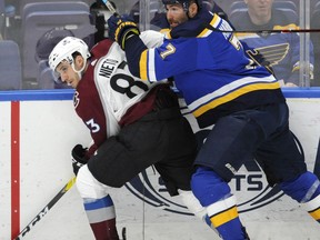 St. Louis Blues' Pat Maroon (7) battles for the puck with Colorado Avalanche's Matt Nieto (83) during the first period of an NHL hockey game, Monday, April 1, 2019, in St. Louis.