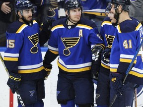 St. Louis Blues' Alexander Steen (20) is congratulated by Robby Fabbri (15) and Robert Bortuzzo (41) after his goal against the Philadelphia Flyers during the third period of an NHL hockey game Thursday, April 4, 2019, in St. Louis.