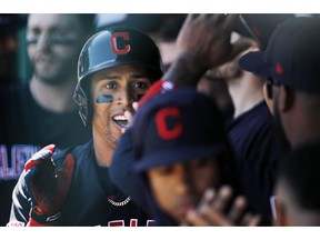 Cleveland Indians' Leonys Martin is congratulated in the dugout after hitting a solo home run in the first inning of a baseball game against the Kansas City Royals at Kauffman Stadium in Kansas City, Mo., Sunday, April. 14, 2019.