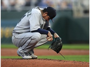 Seattle Mariners starting pitcher Felix Hernandez waits on the mound for a meeting with a trainer and the manager during the first inning of a baseball game against the Kansas City Royals at Kauffman Stadium in Kansas City, Mo., Monday, April 8, 2019.