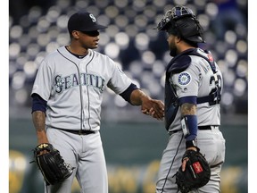 Seattle Mariners relief pitcher Roenis Elias, left, is congratulated by catcher Omar Narvaez following the team's baseball game against the Kansas City Royals at Kauffman Stadium in Kansas City, Mo., Wednesday, April 10, 2019. The Mariners defeated the Royals 6-5.