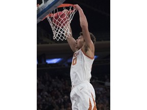 Texas forward Jericho Sims dunks during the first half against Lipscomb in an NCAA college basketball game for the NIT championship Thursday, April 4, 2019, at Madison Square Garden in New York.