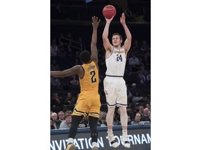 Lipscomb guard Garrison Mathews (24) shoots a 3-point goal past Wichita State guard Jamarius Burton (2) during the first half of a semifinal college basketball game in the National Invitational Tournament, Tuesday, April 2, 2019, at Madison Square Garden in New York.