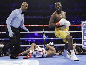 Terence Crawford, right, reacts after knocking down England's Amir Khan during the first round of a WBO world welterweight championship boxing match Sunday, April 21, 2019, in New York. Crawford won the fight.