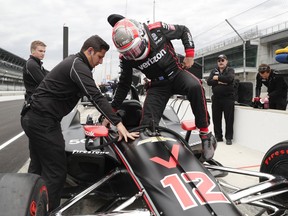 IndyCar driver Will Power, of Australia, climbs into his car during auto racing testing at the Indianapolis Motor Speedway in Indianapolis, Wednesday, April 24, 2019.