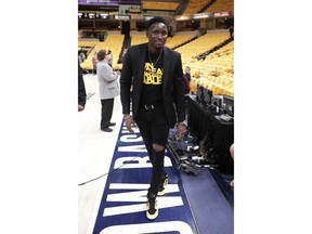 Injured Indiana Pacers guard Victor Oladipo (4) walks down the sideline during warmups before Game 4 of an NBA basketball first-round playoff series against the Boston Celtics in Indianapolis, Sunday, April 21, 2019.