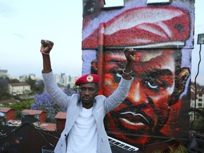 FILE - In this Friday Oct. 12, 2018 file photo, the Ugandan pop star and opposition politician known as Bobi Wine, whose real name is Kyagulanyi Ssentamu, poses next to a mural of himself during a visit to an activists' arts center in Nairobi, Kenya. Wine was remanded to jail on Monday, April 29, 2019 after being charged over his role in a street protest last year against a tax on social media.