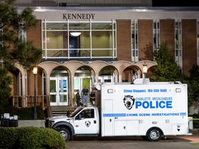 Charlotte-Mecklenburg law enforcement stand in front front of the Kennedy building where a gunman killed two people and injured four students  at UNC Charlotte May 1, 2019 in Charlotte, North Carolina. Campus police responded to the scene on Tuesday and apprehended a suspect, 22-year-old Trystan Andrew Terrell.