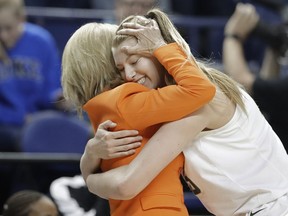 Baylor head coach Kim Mulkey, left, hugs Lauren Cox, right, as she comes off the court on the final moments in the second half of a regional final women's college basketball game against Iowa in the NCAA Tournament in Greensboro, N.C., Monday, April 1, 2019.