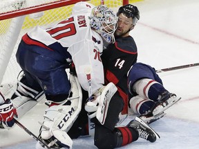Carolina Hurricanes' Justin Williams (14) collides with Washington Capitals goalie Braden Holtby (70) during the second period of Game 6 of an NHL hockey first-round playoff series in Raleigh, N.C., Monday, April 22, 2019.