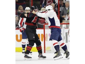 Washington Capitals' Alex Ovechkin, right, of Russia, punches Carolina Hurricanes' Andrei Svechnikov, also of Russia, during the first period of Game 3 of an NHL hockey first-round playoff series in Raleigh, N.C., Monday, April 15, 2019.