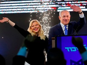 Israeli Prime Minister Benjamin Netanyahu and his wife Sara greet supporters at his Likud Party headquarters in Tel Aviv on election night April 10, 2019.