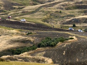 Cypriot investigators and police officers search a field where a body were found, outside of Orounta village, near the capital Nicosia, Cyprus, Monday, April 25, 2019. Police in Cyprus confronted the possibility Thursday that a serial killer had been at large in their midst after an army captain in custody for the deaths of two women claimed responsibility for more slayings, seven in all.(AP Photo)