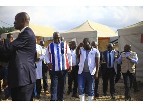 Congo's president, Felix Tshisekedi, center, visits an Ebola treatment centre in Beni, Eastern Congo, Tuesday April.16, 2019. Congo's president on Tuesday said he wants to see a deadly Ebola virus outbreak contained in less than three months even as some health experts say it could take twice as long.