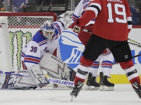 New York Rangers goaltender Henrik Lundqvist (30), of Sweden, makes a save against the New Jersey Devils during the first period of an NHL hockey game, Monday, April 1, 2019, in Newark, N.J.