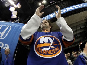 A spectator reacts during the first period of Game 1 of an NHL hockey second-round playoff series between the New York Islanders and the Carolina Hurricanes, Friday, April 26, 2019, in New York.