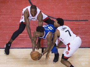 Philadelphia 76ers guard Jimmy Butler (23) battles off Toronto Raptors guard Kyle Lowry (7) and Raptors centre Serge Ibaka (9) during second half, second round NBA basketball playoff action in Toronto, on Monday, April 29, 2019. The Toronto Raptors regrouped Tuesday after an off-night in Game 2 blunted the momentum from a dominating performance in the opener of their second-round series against Philadelphia.