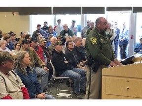 FILE - In this Wednesday, March 20, 2019, file photo, An overflowing crowd packs the Elko County Commission chamber as Elko County Sheriff Aitor Narvaiza presents his case for the county to declare a "Second Amendment sanctuary" in Elko, Nev. A gun control lobbying organization is adding Nevada to efforts to show gun rights groups including the National Rifle Association are behind a "Second Amendment sanctuary" drive in several states. The Brady advocacy group said Tuesday, April "16, 2019, it's filing public records requests for communications in Douglas, Elko, Lyon and Nye county, and with Eureka, Pershing and Nye county sheriff's.