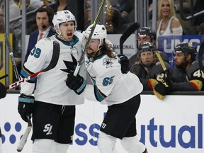 San Jose Sharks defenseman Erik Karlsson, right, celebrates after center Logan Couture, left, scored against the Vegas Golden Knights during the first period in Game 6 of a first-round NHL hockey playoff series Sunday, April 21, 2019, in Las Vegas.