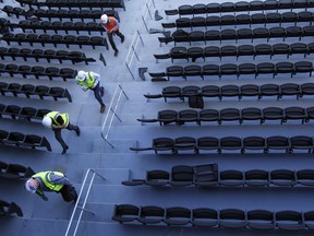 In this, March 28, 2019, photo, people walk through the stands during construction on a new baseball park in Las Vegas. The park will be the home of the minor league Las Vegas Aviators.