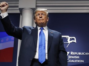 President Donald Trump holds up his fist as he finishes his speech at the Republican Jewish Coalition's annual leadership meeting, Saturday April 6, 2019, in Las Vegas.