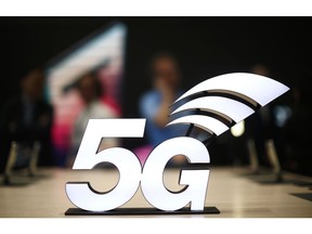 FILE - This Feb. 25, 2019 file photo shows a banner of the 5G network is displayed during the Mobile World Congress wireless show, in Barcelona, Spain.  The U.S. communications regulator will hold a massive auction to bolster 5G service, the next generation of mobile networks, and will spend $20 billion for rural internet.  5G will mean faster wireless speeds and has implications for technologies like self-driving cars and augmented reality.   The Federal Communications Commission said Friday, April 12,  that it would hold the largest auction in U.S. history, of 3,400 megahertz, to boost wireless companies' networks.