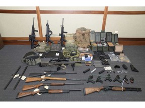 FILE - This image provided by the U.S. District Court in Maryland shows a photo of firearms and ammunition that was in the motion for detention pending trial in the case against Christopher Paul Hasson.  The Coast Guard officer accused of stockpiling guns and compiling a hit list of prominent Democrats and network TV journalists is seeking his release from federal custody since prosecutors haven't charged him with any terrorism-related offenses. Hasson has remained in custody since his Feb. 15, 2019 arrest and subsequent indictment in Maryland on firearms and drug charges.  (U.S. District Court via AP, File, File)