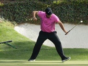 FILE - In this April 8, 2018, file photo, Patrick Reed reacts to his birdie on the 12th hole during the fourth round at the Masters golf tournament in Augusta, Ga. Reed will try to become the first back-to-back Masters champion since Tiger Woods in 2002.
