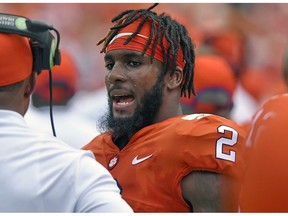 FILE - In this Sept. 1, 2018, file photo, Clemson quarterback Kelly Bryant talks to a Clemson coach on the sidelines during the first half of an NCAA college football game against Furman, in Clemson, S.C. The former Clemson standout was benched in favor of freshman quarterback Trevor Lawrence following the Tigers' Week 4 win over Georgia Tech, and immediately became of the most sought-after transfers in the country. On Dec. 4, 2018, Bryant announced in a video he was transferring to Missouri.
