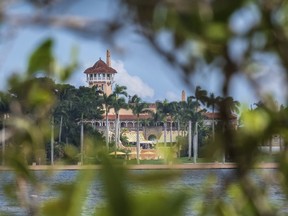 FILE - This Nov. 23, 2018 file photo shows President Donald Trump's Mar-a-Lago estate behind mangrove trees in Palm Beach, Fla. On Saturday, March 30, 2019, a woman carrying two Chinese passports and a device containing computer malware lied to Secret Service agents and briefly gained admission to the club over the weekend during his Florida visit, federal prosecutors allege in court documents.