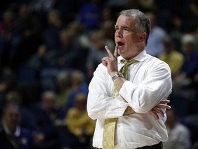 FILE - In this Feb. 28, 2019, file photo, Wofford coach Mike Young yells to his players during the second half of an NCAA college basketball game against Chattanooga in Chattanooga, Tenn. Virginia Tech has hired Young to replace Buzz Williams. The school announced the decision Sunday night, April 7. Young is scheduled to be formally introduced during a news conference Monday morning.