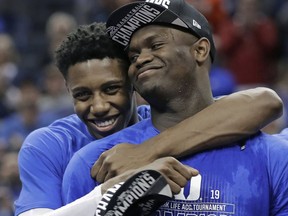 FILE - In this March 16, 2019, file photo, Duke's RJ Barrett, left, hugs Zion Williamson after Duke defeated Florida State in the NCAA college basketball championship game of the Atlantic Coast Conference tournament, in Charlotte, N.C. Duke's Zion Williamson and R.J. Barrett are the second freshman teammates to earn first-team All-America honors. Williamson and Barrett headed The Associated Press All-America team released on Tuesday, April 2, 2019, joined by Tennessee's Grant Williams, Murray State's Ja Morant and Cassius Winston of Michigan State.