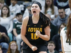 FILE - In this Dec. 30, 2018, file photo, Iowa's Megan Gustafson (10) reacts against Michigan State during an NCAA college basketball game, in East Lansing, Mich. Gustafson, who averaged a Division I-best 28 points while also ranking second in rebounding, was selected to The Associated Press women's All-America first team, Monday, April 1, 2019.