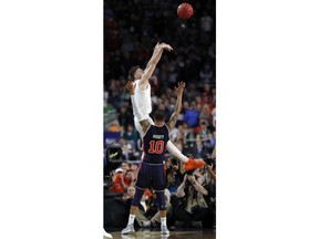 FILE - In this April 6, 2019, file photo, Virginia's Kyle Guy shoots as he was fouled by Auburn's Samir Doughty (10) during the second half in the semifinals of the Final Four NCAA college basketball tournament, in Minneapolis. Guy sank all three free throws and Virginia defeated Auburn 63-62.