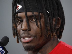 FILE - In this Jan. 18, 2019, file photo, Kansas City Chiefs wide receiver Tyreek Hill talks to the media after a workout in Kansas City, Mo. The Kansas City Chiefs have made a habit of inciting controversy during the NFL draft in the Andy Reid era by acquiring players that have a history of off-the-field issues. The team took a chance on cornerback Marcus Peters, who was traded away after getting into trouble with coaches. It drafted running back Kareem Hunt, then quickly cut him when he kicked a woman in a hotel hallway. And it picked wide receiver Tyreek Hill, who is currently dealing with a domestic violence case that centers on the 3-year-old child he shares with his fiance.