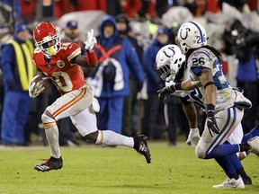 FILE - In this Jan. 12, 2019, file photo, Kansas City Chiefs wide receiver Tyreek Hill (10) gives Indianapolis Colts linebacker Anthony Walker (50) and safety Clayton Geathers (26) the peace sign as he rushes for a first down during an NFL AFC Divisional football game at Arrowhead Stadium in Kansas City, Mo. The Kansas City Chiefs have made a habit of inciting controversy during the NFL draft in the Andy Reid era by acquiring players that have a history of off-the-field issues. The team took a chance on cornerback Marcus Peters, who was traded away after getting into trouble with coaches. It drafted running back Kareem Hunt, then quickly cut him when he kicked a woman in a hotel hallway. And it picked wide receiver Tyreek Hill, who is currently dealing with a domestic violence case that centers on the 3-year-old child he shares with his fiance.