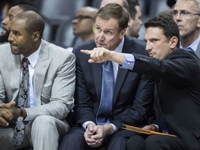 FILE - In this Wednesday, Oct. 11, 2017 file photo, Portland Trail Blazers head coach Terry Stotts, center, sits between assistant coaches David Vanderpool, left, and Nate Tibbetts, right, as they play the Phoenix Suns during the second half of an NBA preseason game in Phoenix. A person familiar with the team's plans says the Cavaliers intend to interview Portland assistants Nate Tibbetts and David Vanterpool for their coaching job. Cleveland has received permission to speak with Tibbetts and Vanterpool, said the person who spoke to The Associated Press on condition of anonymity because of the sensitivity of the talks, Tuesday, April 23, 2019.