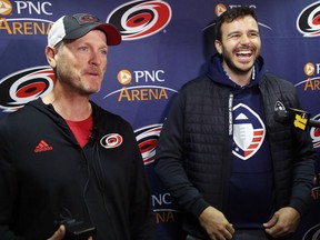 FILE - In this Feb. 19, 2019, file photo, Tom Dundon, left, majority owner of the Carolina Hurricanes, and Charlie Ebersol, co-founder and CEO of the Alliance of American Football, talk to the media in Raleigh, N.C. The Alliance of American Football is suspending operations eight games into its first season. A person with knowledge of the decision tells The Associated Press the eight-team spring football league is not folding, but games will not be played this weekend. The decision was made by majority owner Tom Dundon. The person spoke to The Associated Press on condition of anonymity because league officials were still working through details of the suspension. An announcement from the league is expected later Tuesday, April 2, 2019.