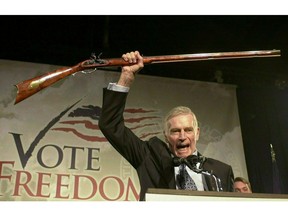 FILE - In this Oct. 21, 2002 file photo, National Rifle Association President Charlton Heston holds up a rifle as he addresses gun owners during a "get-out-the-vote" rally in Manchester, N.H. While American gun-rights are enshrined in the U.S. Constitution - something that doesn't translate to most countries around the world - the NRA's track record of aggressively shaping the debate has nevertheless turned it into the go-to group for other gun-rights activists outside the U.S.