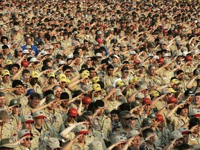 FILE - In this July 31, 2005 file photo, Boy Scouts salute as they recite the Pledge of Allegiance during the Boy Scout Jamboree in Bowling Green, Va. In 2019, financial threats to the Boy Scouts have intensified as multiple states consider adjusting their statute-of-limitations laws so that victims of long-ago child sex-abuse have a chance to seek redress in the courts.