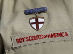 FILE - This Feb. 4, 2013 file photo shows a meal pin on a Boy Scout's uniform in Irving, Texas. Under pressure over its past problems with child sex-abuse, the Boy Scouts of America defended its current prevention policies on Wednesday, April 24, 2019 and said there were only five known victims in 2018 of out roughly 2.2 million youth members.