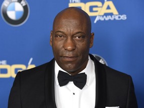 FILE - In this Feb. 3, 2018 file photo, John Singleton arrives at the 70th annual Directors Guild of America Awards in Beverly Hills, Calif. The "Boyz N the Hood" director suffered a stroke last week and remains hospitalized, according to a statement from his family on Saturday, April 20, 2019.