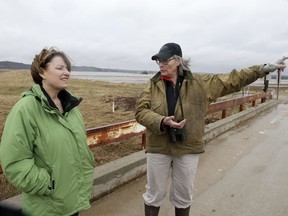 FILE - In this Friday, March 29, 2019 file photo, resident Fran Karr, right, points out to Democratic presidential candidate Sen. Amy Klobuchar, D-Minn., the flooded areas around her home in Pacific Junction, Iowa.