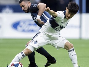 FILE - In this April 5, 2019, file photo, Vancouver Whitecaps' Inbeom Hwang, right, and Los Angeles Galaxy's Romain Alessandrini vie for the ball during the first half of an MLS soccer game in Vancouver, British Columbia. Alessandrini will be sidelined until September after undergoing his third knee surgery. The Galaxy announced Friday, April 26, 2019, that Alessandrini needed meniscus root repair in his left knee after getting hurt two weeks ago.