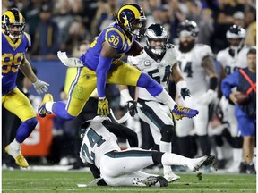 FILE - In this Dec. 16, 2018, file photo Los Angeles Rams running back Todd Gurley runs against the Philadelphia Eagles during the first half in an NFL football game in Los Angeles. Gurley still is not shedding much light on the injured knee that limited him down the stretch with the Rams. He was in camp for the opening of the Rams' offseason program Monday, April 15, 2019, in their first team activities since their Super Bowl loss to New England.